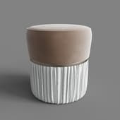 a small pouf with a velour top