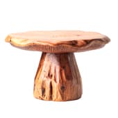 the "mushroom" coffee table is a handmade sculptural table made of solid wood with a tabletop that preserves the natural edge and a ribbed base.
