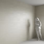 The wall is made of white concrete tiles