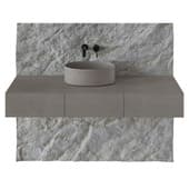 a cabinet with an overhead sink and a stone panel in the bathroom