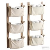 a set of towels in cloth bags (on a wooden base)